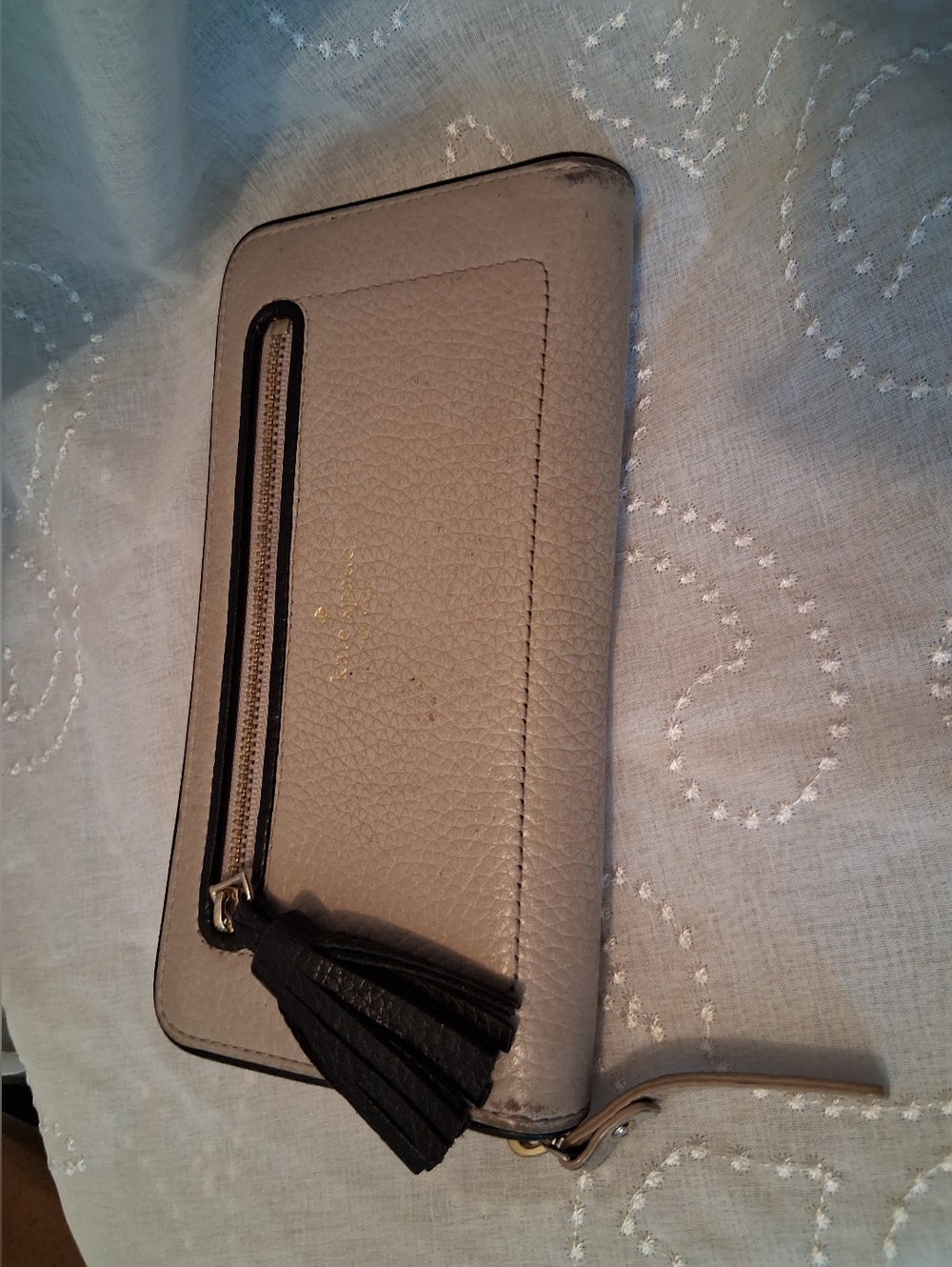 kate spade taupe pebbled leather wristlet with black tassel